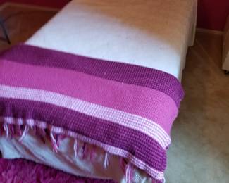 Twin bed with vintage bedspread.