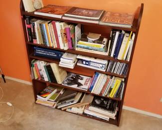 Bookshelf with mostly non fiction books on travel, history, religion, and more.