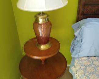 Two tiered round vintage table with cranberry glass lamp