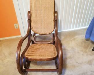 Cane rocker is one of 3 rocking chairs