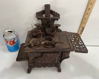 VINTAGE MINIATURE CRESCENT CAST IRON STOVE 	HAS ALL THE POTS/PANS AND PIECES 