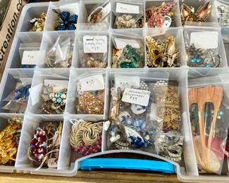 Lots of clip earrings, pins, brooches.