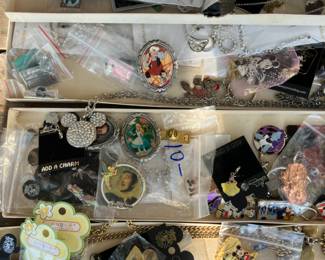4 boxes full of 80's and 90's Disney jewelry , pins , key chains, charms never used