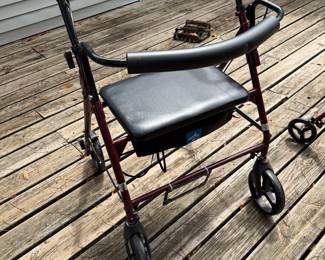 Rollator with brakes and storage area under seat