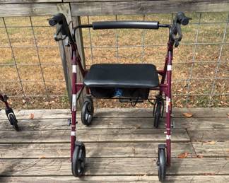 Rollator with brakes and storage area under seat