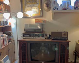 The console television is also supporting the record player, a vintage AM/FM radio, and the Panasonic 8-track player. Don't forget the framed artwork and floor lamp.