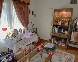 In this photo, another lighted display cabinet is shown. Again, there are dolls and figurines inside.