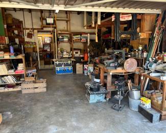 Here is a garage overview. The 10" bench saw is on the floor next to the workbench with the large sanding disc.