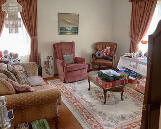 This is an overview of the living room, including the coffee table, the two chairs, a sofa, and the rug. Dont' forget the rug.