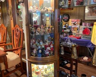 This is one of the lighted display cabinets in the sale. Lots of dolls and figurines are inside the cabinet.