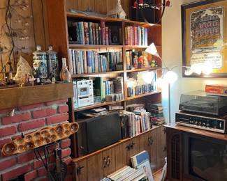 Here is another bookcase with more books. On the floor are several LP albums for the phonograph.