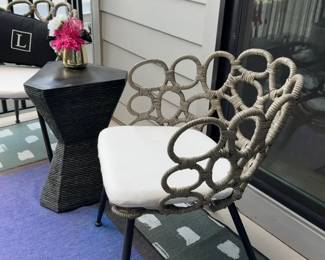 Woven Outdoor Chair with Cushion and Black Geometric Accent Table