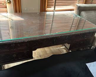 #109 - $500 - Spanish tress base carved desk with glass top 57wx30x31t
