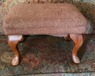 small upholstered footstool with wooden legs. $25