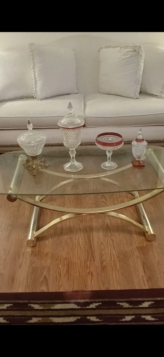 Glass antique vintage table along with table glass decorations also included is Victorian sofa along with pillows