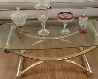 Glass antique vintage table along with table glass decorations also included is Victorian sofa along with pillows