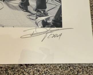 This is a professional photo as part of the collection of Ms. Broyles featuring musicians in action and is signed by the artist. 