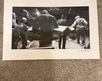 This is a professional photo as part of the collection of Ms. Broyles featuring musicians in action and is signed by the artist. 