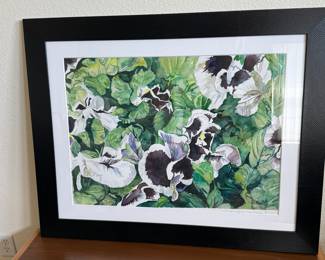 Framed artwork featuring a vibrant floral watercolor design, primarily depicting green foliage with black and white pansy flowers. The frame is black with a textured finish, and the matting is white. The artist's signature, 'Gwen Marue' is visible in the lower corner.

Art Field measures 21” x 29”. Overall measurement is 31 1/2” x 39 1/2”. See minor condition issue of the watercolor slipping from mount. This is easily repaired by a professional framer. Minor condition issues with frame. 