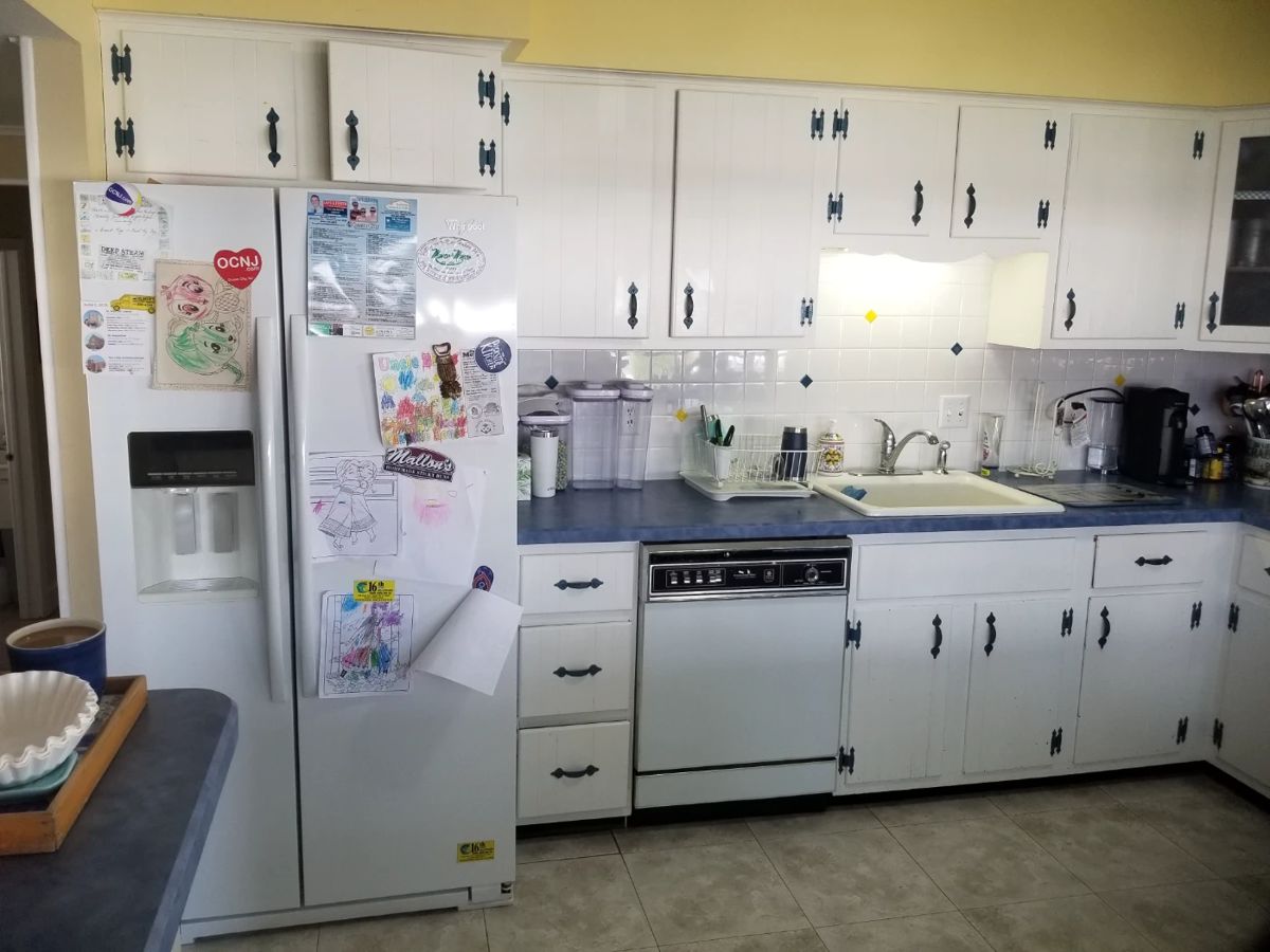 Classic painted white kitchen cabinets with wrought iron hardware