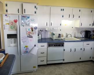 Classic painted white kitchen cabinets with wrought iron hardware