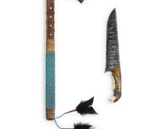 340
Byron Yabumoto Quimbey
(1946-2004)
Two Lithic Art Items, late 20th century
Knapped flint, wood, bone, leather, sinew, beadwork
Comprising a flint axe with studded and beaded shaft, and black feather dangles, as well as a flint knife bound to an animal jawbone, with beadwork and sinew accents
2 pieces
Axe: 24" H x 12" W x 0.875" D, Feathers: 10.5"; Knife: 16" H x 2.5" W x 0.75" D
Estimate: $400 - $600