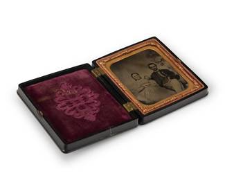 220
A Civil War era tintype
A tintype depicting a family portrait, with a chased gold-toned metal preserver within a magenta-lined thermoplastic case
Sight: 2.75" H x 2.25" W
Estimate: $300 - $500