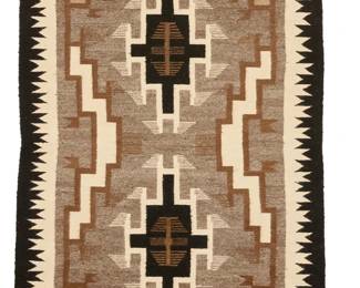 67
A Navajo Two Grey Hills rug
Mid/late 20th century, Diné
Woven in white, light brown, variegated brown, variegated grey, tan, and black wool with two central stepped hooked diamonds with elaborate stepped hooked corners and side motifs, and a variable sawtooth border on two sides
68" H x 37" W approximately
Estimate: $400 - $600