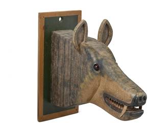 153
A Folk Art carved wood wolf trophy/plaque
Late 20th/21st century
Unsigned
A large sculpted wolf head effigy of carved wood sections covered with embossed textured foil, with polychrome painted features, metal teeth, and resin eyes; the head mounted to a painted wood plaque
26.75" H x 11.75" W x 29" D
Estimate: $300 - $500