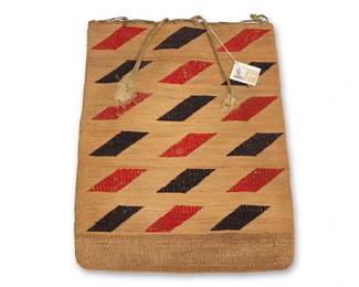 55
A Nez Perce twined corn husk bag
Late 19th/early 20th century, Nimiipuu; Northwest Plateau
The double-sided flat twined bag with polychrome wool yarn imbricated motifs to each side, featuring three columns of serrated diamonds to one side, and six rows of alternating red and black parallelograms verso, with rawhide lacing to top edge and knotted rawhide straps attached to one side
19" H x 15" W
Estimate: $1,000 - $1,500