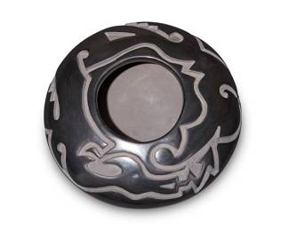 16
Jason Ebelacker (b. 1980, Santa Clara Pueblo)
A Santa Clara blackware pottery jar, late 20th/21st century
With incised signature to underside: J L Ebelacker / Santa Clara Pueblo
A stone-polished tapered globular wide jar with deeply carved curvilinear Avanyu motif to shoulders
3.75" H x 9" Dia.
Estimate: $500 - $700