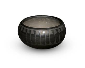 10
Crucita "Blue Corn" Calabaza (1921-1999, San Ildefonso Pueblo)
A blackware bowl, mid/late 20th century
Incised to underside: Blue Corn / San Ildefonso Pueblo
A stone-polished black on black low rounded bowl with a band of feather motifs
2.375" H x 4.625" Dia.
Estimate: $300 - $500
