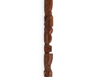 301
William Dennis, Sr.
(b. 1923, Nuu-chah-nulth/Nootka, Ohiaht Band)
"Talking Stick," mid/late 20th century
Carved wood, likely cedar
A carved narrow "speaker's staff," with multiple animal and figural totem figures, including eagles, killer whale, and raven, with original tag denoting artist and title, signed in ink to handle verso: Wm. Dennis, Sr.
47.75" H x 1.625" W x 1.625" D
Estimate: $200 - $300