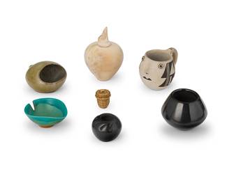 337
A collection of miniature Southwest-style pottery
Late 20th century
Five variously marked for maker
Comprising a Denny Guiterrez 1991 Santa Clara Pueblo blackware shouldered jar, A Lucero Santa Clara incised blackware jar, an Anita Lowden Acoma Pueblo black-on-white small face motif handled jar, a polished fire-clouded beige tapered lidded jar/deed pot with "howling wolf" lid/stopper, as well as two small green-glazed modernist-style miniature ashtrays, including one with notch marked Cohn, and one olive green unmarked, and a small lidded basket
7 pieces
Largest: 4.25" H [with lid] x 2.875" Dia.; Smallest: 1.5" H x 2" Dia.; Basket: 1.25" H x 1" Dia.
Estimate: $200 - $400