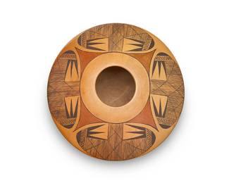 125
Dextra Quotskuyva Nampeyo (1928-2019, Hopi-Tewa)
A polychrome yellowware pottery jar, late 20th/early 21st century
Signed to underside with artist's corn cipher: Dextra
The three-color jar with the Nampeyo family's signature migration motif at shoulder, above an unburnished body
3.75" H x 7.125" Dia.
Estimate: $500 - $700