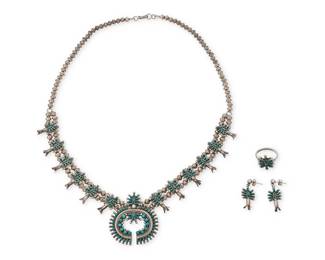 312
A set of Norman & Virginia Hooee Zuni turquoise petit point jewelry
Norman and Virginia Hooee (b. 20th century, Zuni)
Mid/late 20th century
Necklace stamped: NVH / Zuni NM
Comprising a diminutive sterling silver squash blossom necklace with a petit point and cluster-set turquoise naja and twelve blossoms on a double strand of small silver beads, together with a matching ring as well as a pair of earrings
4 pieces
Necklace: 23" L x 1.75" H; ring: size 6.5; earrings: 1" H
55.5 grams gross
Estimate: $700 - $900