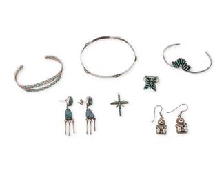 335
A group of Southwest silver and turquoise jewelry
Late 20th/21st century
Variously marked for maker and for sterling: AB / CFD 90 / Claudine [likely Pentakewa; etched] Zuni / Cliff Jamon
Seven works comprising two bracelets by Cliff Jamon (b. 1953, Zuni), including a delicate three-wire cuff with narrow set needlepoint turquoise, and a narrow flat wire bangle with spaced needlepoint turquoise, together with a Claudine [Pentakewa] Zuni delicate single wire and turquoise needlepoint set cuff, a Zuni-style needlepoint butterfly ring, a needlepoint cross pendant,
as well as two pairs of earrings, one pair with nugget turquoise dangles and one pair with sterling silver storyteller figures
9 pieces
Cuffs: each 6.25" inner C; Bangle: 8.25" inner C; Ring size: 6.25; Pendant: 1.375" H; Earrings: 2" H & 1.5" H
45.3 grams gross
Estimate: $500 - $700