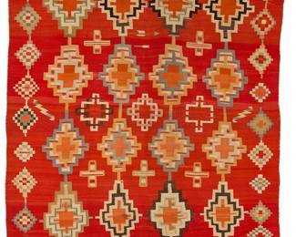 60
A Navajo Germantown weaving
Late 19th century, Diné
Woven in red and multicolored wool featuring four rows of stepped diamonds, floating crosses and a border of stepped diamonds and decorative stitched edges to two ends.
51" H x 64" W
Estimate: $8,000 - $12,000