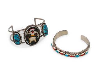 322
Two Southwest silver and stone set cuff bracelets
Late 20th/21st century
Two works:

A Wilbert Benally Navajo sterling silver and stone set cuff
(b. 20th century, Diné)
Marked: WB / Sterling
A narrow cuff with row-set coral and turquoise and elaborate stampwork to edges
6.625" total inner C x 0.625" H, with a 1" gap

A Zuni-style Gan dancer stone inlay cuff
Unmarked
A two-wire sterling silver cuff with central figural plaque with turquoise, shell and coral inlay, flanked by two set turquoise oval cabochons
7" total inner C x 1.75" H, with a 1.75" gap

62.1 grams gross
2 pieces
Estimate: $300 - $500