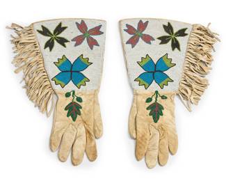 290
A pair of Plateau beaded gauntlet gloves
Mid-20th century; Northwest United States/Canada
The pair of beaded hide gloves with multicolored beaded floral and botanical motifs to fringed gauntlet tops, the gauntlets lined with printed cotton calico
2 pieces
Each: 17.5" L from tip to opening x 8.75-8.5" W at wrist approximately
Estimate: $500 - $700