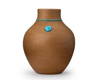 19
Dora Tse Pe (b. 1939, Zia Pueblo/San Ildefonso Pueblo)
A San Ildefonso micaceous buff pottery jar, 1983
Signed and dated to underside: Dora Tse Pe / San Ildefonso Pueblo / 1983
The small micaceous rounded vase with a ring of inset turquoise heshi to the neck, and a single turquoise cabochon
5.375" H x 4.25" Dia.
Estimate: $500 - $700