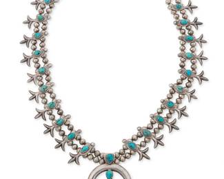 309
A Southwest sterling silver and turquoise squash blossom necklace
Late 20th century
Unmarked
With a central stone-set cast silver naja and twenty "fleur de lis" style blossoms, all suspended from a double strand of silver beads
29" L x 2.75" H
221.6 grams gross
Estimate: $800 - $1,200