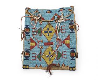 288
A Plains beaded hide bag
Late 19th/early 20th century; Northern/Central Plains
The rectangular bag with polychrome beadwork on a blue ground with multiple stacked geometric motifs, flap top closure, and with quilled hide lacings with metal cone tips, horsehair dangles, and a beaded border trim verso
11.75" H x 10" W
Estimate: $500 - $700