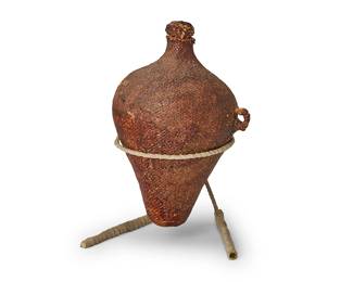 176
A Paiute basketry water vessel
Early/mid-20th century; Great Basin
The twined conical bottle neck jar sealed with pine resin pitch, with two integral handles to one side and a stopper, with custom stand
10.5" H (with stopper) x 6" Dia.; with stand: 11" H
Estimate: $300 - $500