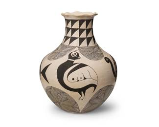 304
An Acoma Pueblo Mimbres-style pottery vase
Mid/late 20th century; New Mexico
Signed to underside: E.C. / Acoma, NM
The tall long-necked jar with ruffled "pie crust" rim and black-on-white pictorial motifs including birds, turtle, fish and other fine-line geometric motifs
11" H x 9.5" Dia. approximately
Estimate: $600 - $900