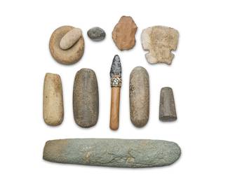 341
A group of stone implements
Pre-historic or later
Comprising a group of carved stone objects including a small paint mortar and pestle, four further stone pestles of various sizes, two from Oregon, as well as a small round stone, likely a Chumash stone, from Southern California, two knapped blades, one from New Mexico, and one likely from the Midwest, a long curved grinding stone, and a reproduction Chumash knife, with Paiute knapped point mounted to a wood shaft, with shell inlay to bituminous-like band to top
11 pieces
Largest: 15" L x 3.5" Dia.; Smallest 1.5" H x 2" W x 1.75" D; Knife: 8.5" H x 1.5" W x 1" D
Estimate: $200 - $400