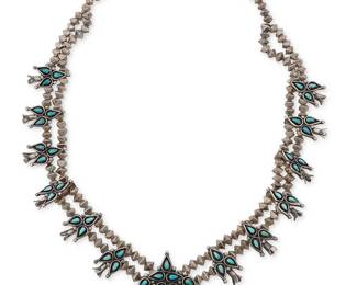 313
A Southwest silver and turquoise squash blossom necklace
Late 20th century
Unmarked
With a small teardrop cluster-set turquoise and sterling silver naja and twelve clustered blossoms, all set on double strands of pyramidal silver beads
25.5 " L x 2" H
99.6 grams gross
Estimate: $500 - $700