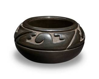 9
Margaret Tafoya (1904-2001, Santa Clara Pueblo)
A Santa Clara Pueblo blackware pottery jar, mid/late 20th century
With incised signature to underside: Margaret Tafoya / Santa Clara Pue
The stone-polished globular jar with a deep incised continuous, undulating geometric pattern
4.5" H x 8.25" Dia.
Estimate: $800 - $1,200
