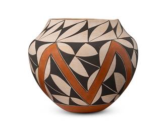 282
Emmalita "Charlie" Chino (b. 1931, Acoma Pueblo)
An Acoma Pueblo polychrome pottery olla, circa 1984
Signed to base: Emma Chino / Acoma / N. Mex.
The rounded jar with black on white and red zigzag and stylized triangular motifs, with a red base
8" H x 9" Dia.
Estimate: $200 - $400