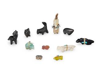 336
A group of Southwest Pueblo carved stone and pottery animal figures
Mid/late 20th century; Santa Clara Pueblo and Zuni Pueblo
Three variously marked for maker
Comprising four Santa Clara Pueblo miniature blackware pottery animals, including a Dorothy Gutierrez howling coyote/wolf, a Candelaria Suazo abstract bear, as well as a blackware pottery owl and a skunk, together with seven Zuni-style carved stone and horn fetish animals and figures, including a Herbert Halate Zuni carved jet mountain lion/puma, a fluorite bear, a white stone mountain lion, a red stone rabbit, an amber ringtail, a grey stone frog, and a carved antler maiden with small child and feathers
11 pieces
Pottery: 3.25" H x 2" W to 2" H x 1.25" Dia. Fetishes: Largest: 1.25" H x 0.75" W x 4.125" D; Smallest: 0.5" H x 1.25" W x 1.375" D
Estimate: $200 - $400